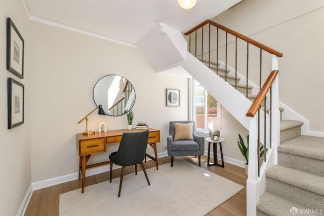a view of a bedroom with furniture and windows