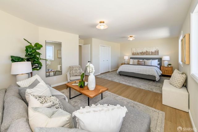 a living room with furniture and a potted plant