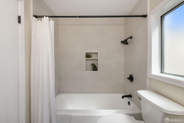 a bedroom with two beds and a large window