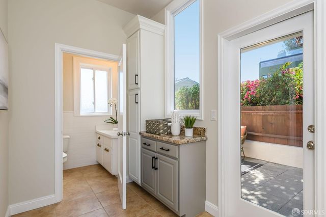 a bathroom with a sink a toilet and mirror