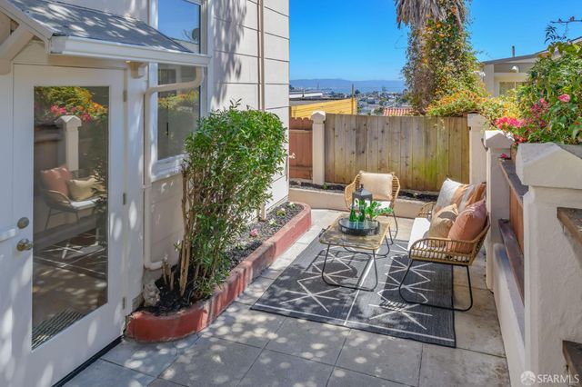 a view of a chairs and table in backyard
