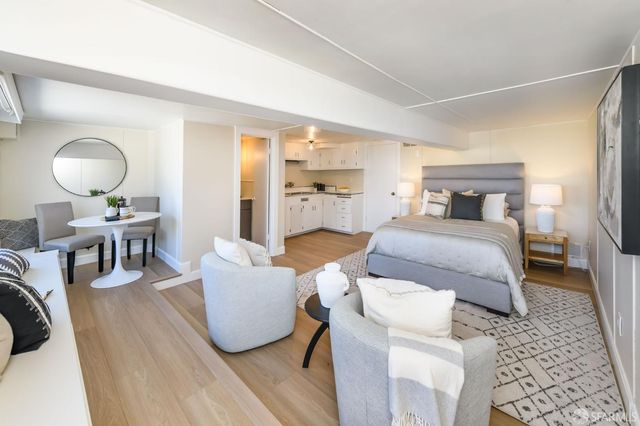 a living room with furniture and a mirror