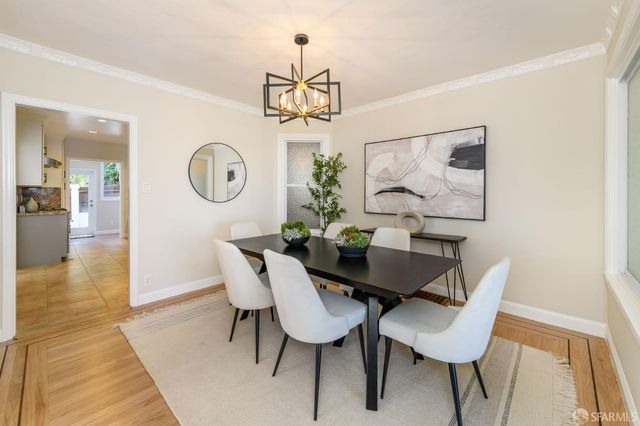 a view of a dining room with furniture wooden floor and chandelier