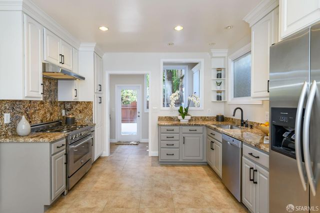 a kitchen with a sink stove and cabinets