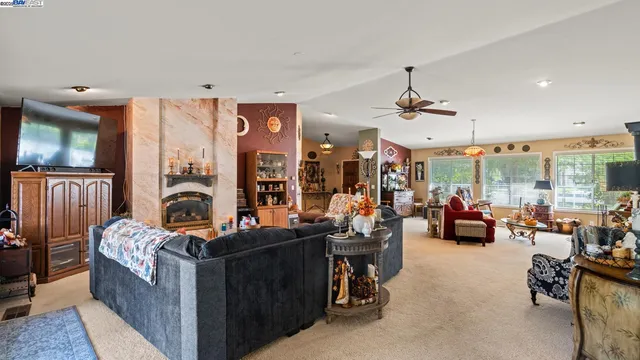 a room with furniture a large window and a chandelier