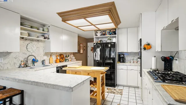 a kitchen with a sink stove and refrigerator