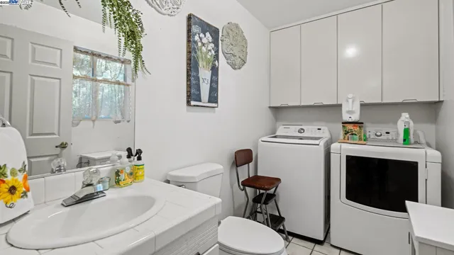 a bathroom with a granite countertop sink a toilet and a mirror
