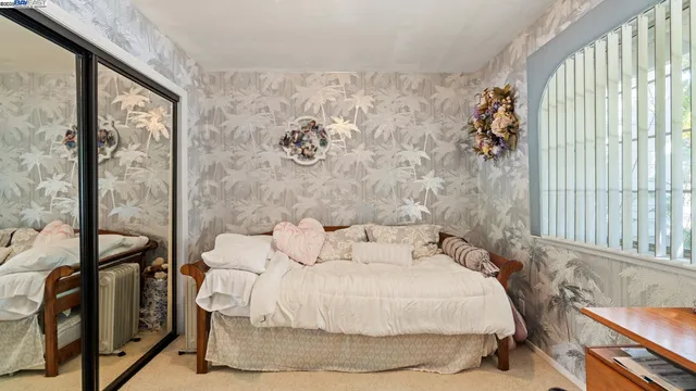 a bedroom with a bed and a window