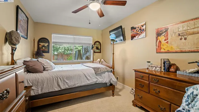 a bedroom with furniture and a flat screen tv