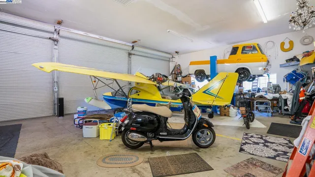 a view of a backyard with table and chairs under an umbrella with large trees
