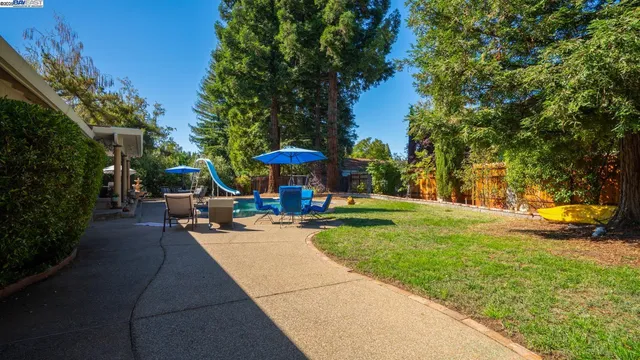 a view of a patio with swimming pool table and chairs