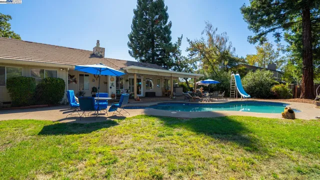 a view of a house with garden and sitting area