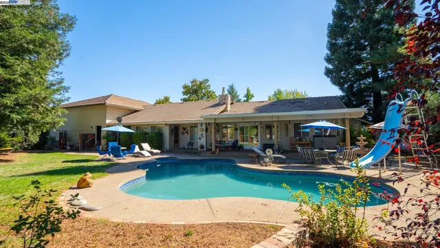 a view of a swimming pool with lounge chair