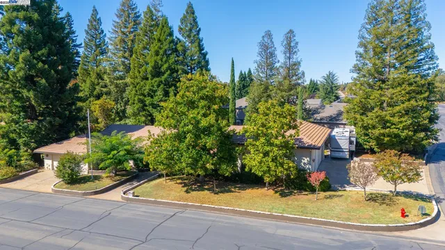 an aerial view of a residential houses with yard