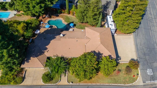an aerial view of a city with lots of residential buildings ocean and mountain view in back