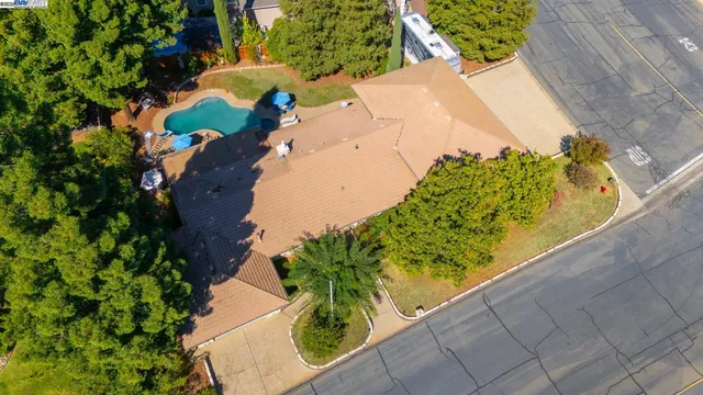 an aerial view of a house with a yard and garden
