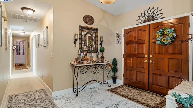 a view of a hallway with wooden floor and furniture