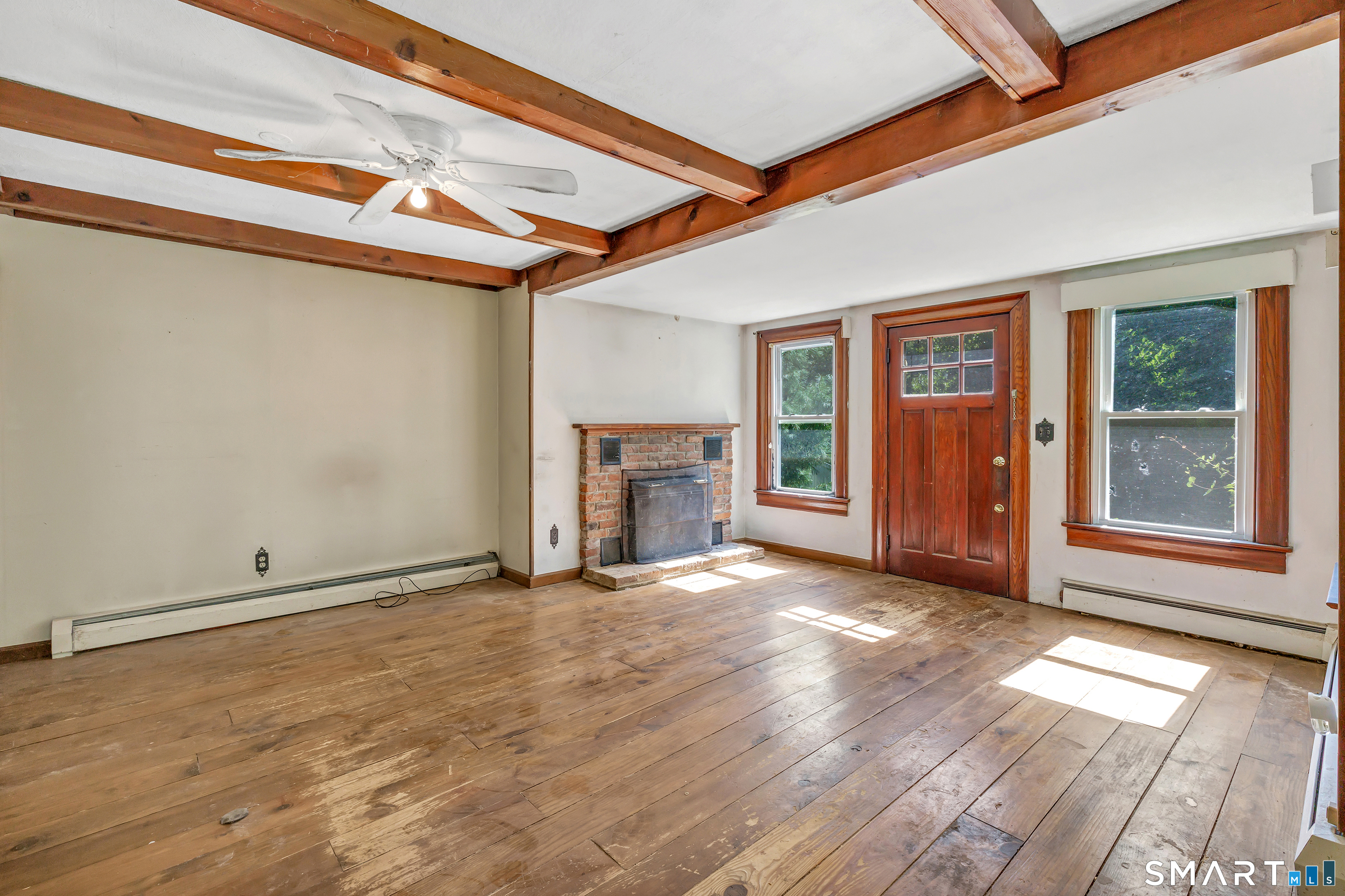 606 North Madison Road Guilford, CT 06437 - Photo 7 of 38 Spacious living area with hardwood flooring, exposed ceiling beams and abundant natural light.