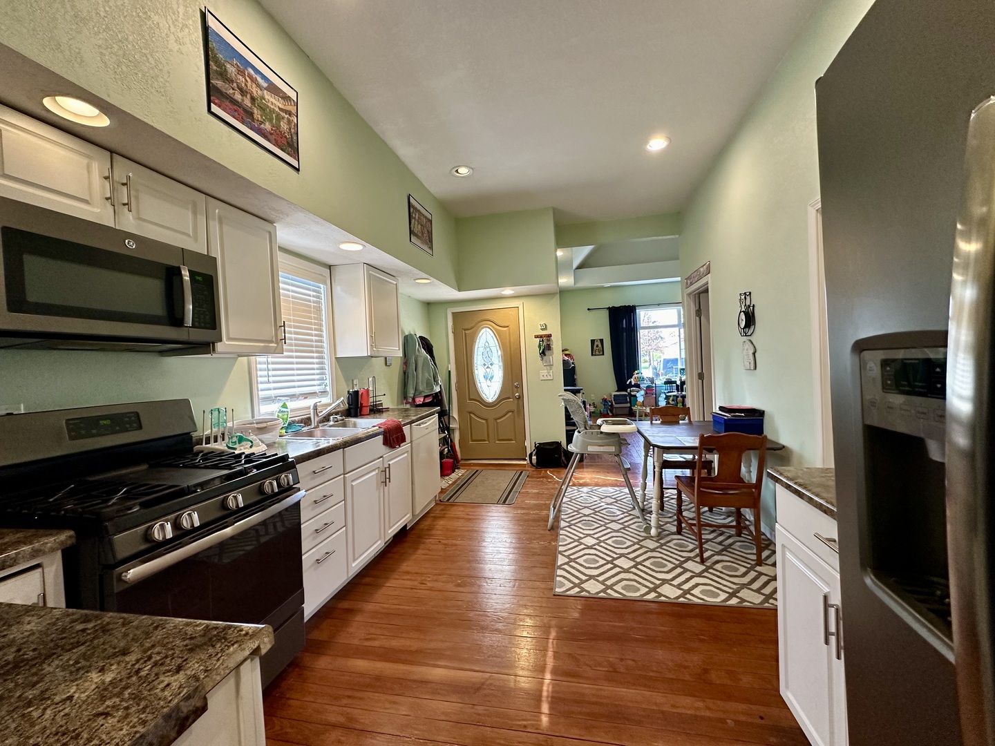 520 Maple Street Weldon, IL 61882 - Photo 5 of 11 a large kitchen with stainless steel appliances granite countertop a stove and a dining table chair