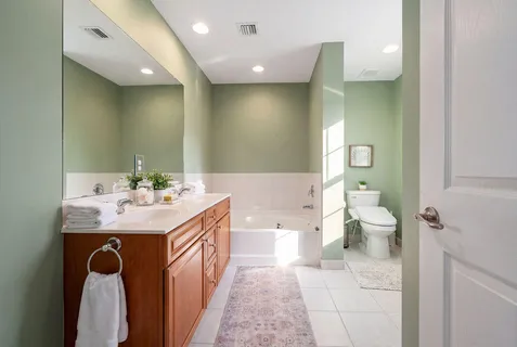 a bathroom with a toilet sink shower and mirror