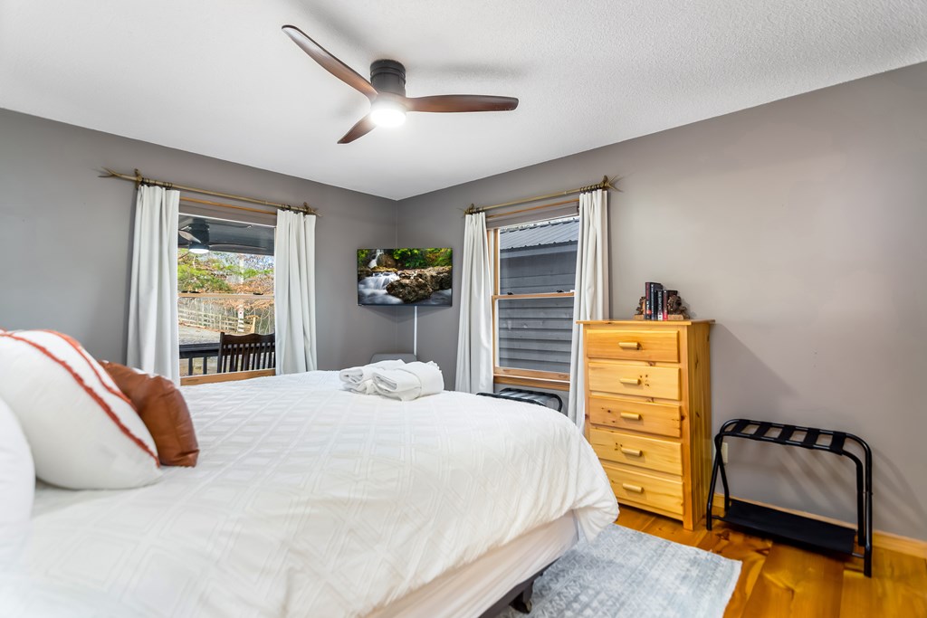 174 Seneca Way Ellijay, GA 30540 - Photo 17 of 36 a bedroom with a bed and wooden floor