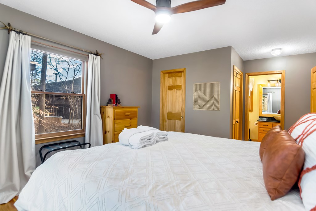 174 Seneca Way Ellijay, GA 30540 - Photo 18 of 36 a bedroom with a bed and wooden floor