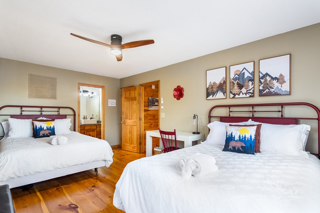 174 Seneca Way Ellijay, GA 30540 - Photo 21 of 36 a bedroom with 2 bed and a painting on the wall