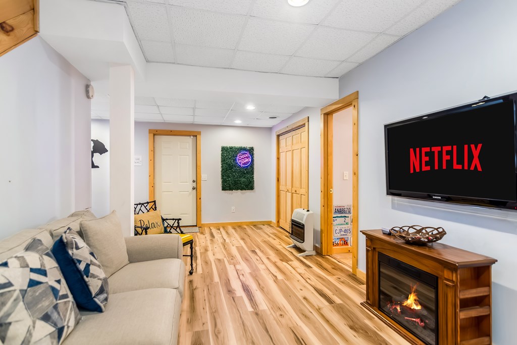 174 Seneca Way Ellijay, GA 30540 - Photo 28 of 36 a living room with furniture a flat screen tv and a fireplace