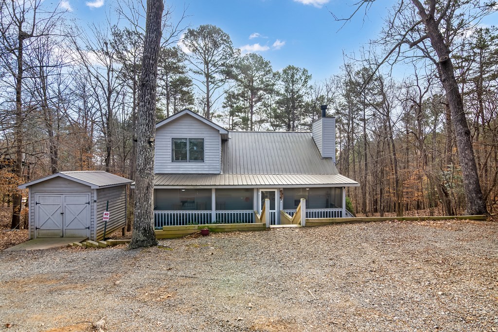 174 Seneca Way Ellijay, GA 30540 - Photo 33 of 36 a front view of a house with a garden and trees