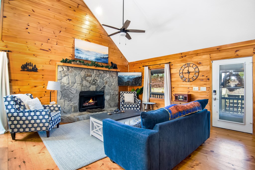 174 Seneca Way Ellijay, GA 30540 - Photo 9 of 36 a living room with furniture a rug and a fireplace