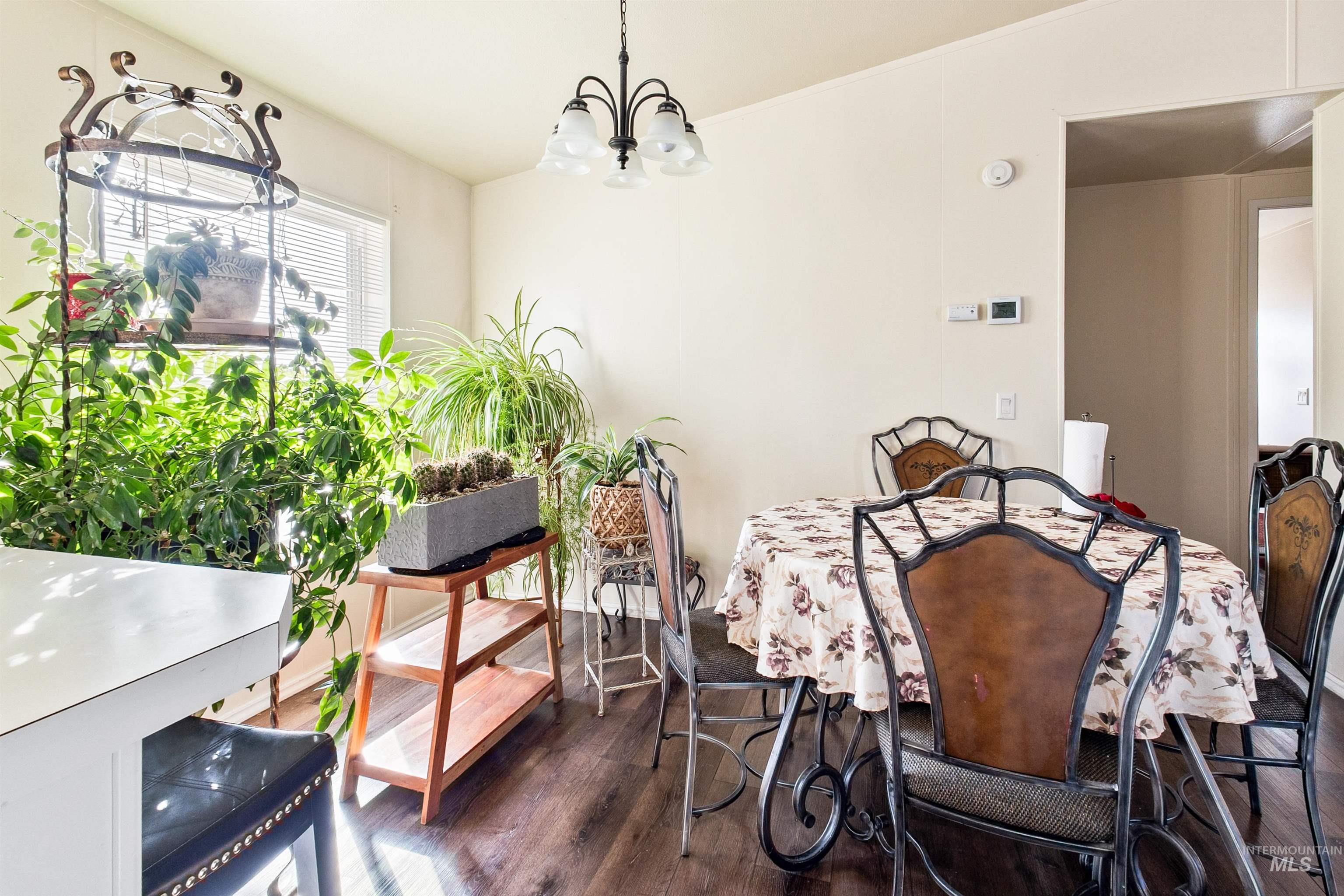 524 West Mesquite Street Boise, ID 83713 - Photo 17 of 29 Dining room with dark wood finished floors and a chandelier