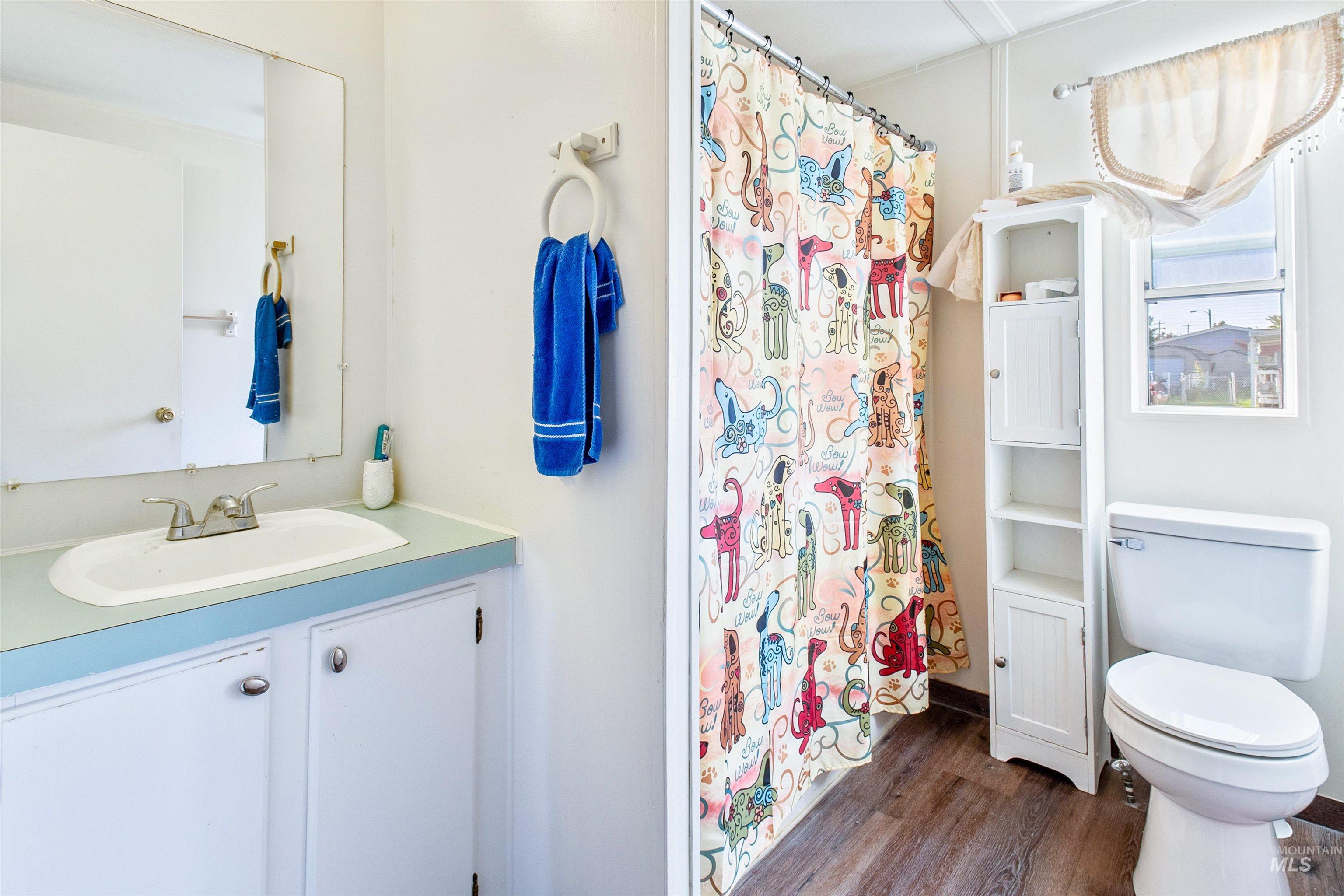 524 West Mesquite Street Boise, ID 83713 - Photo 22 of 29 Full bath with dark wood-style flooring, vanity, and a shower with curtain