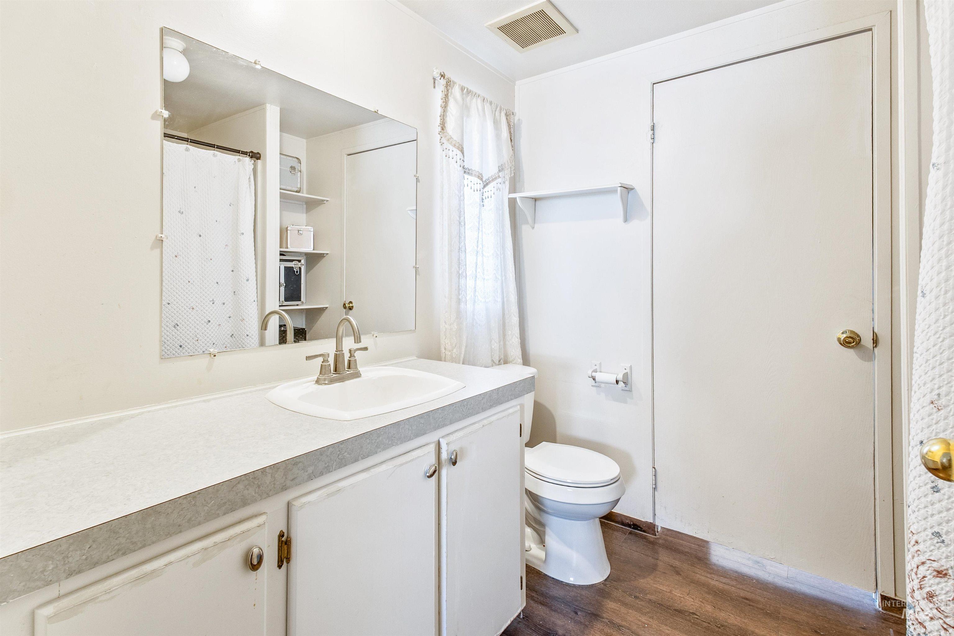 524 West Mesquite Street Boise, ID 83713 - Photo 26 of 29 Full bath with dark wood-style flooring and vanity