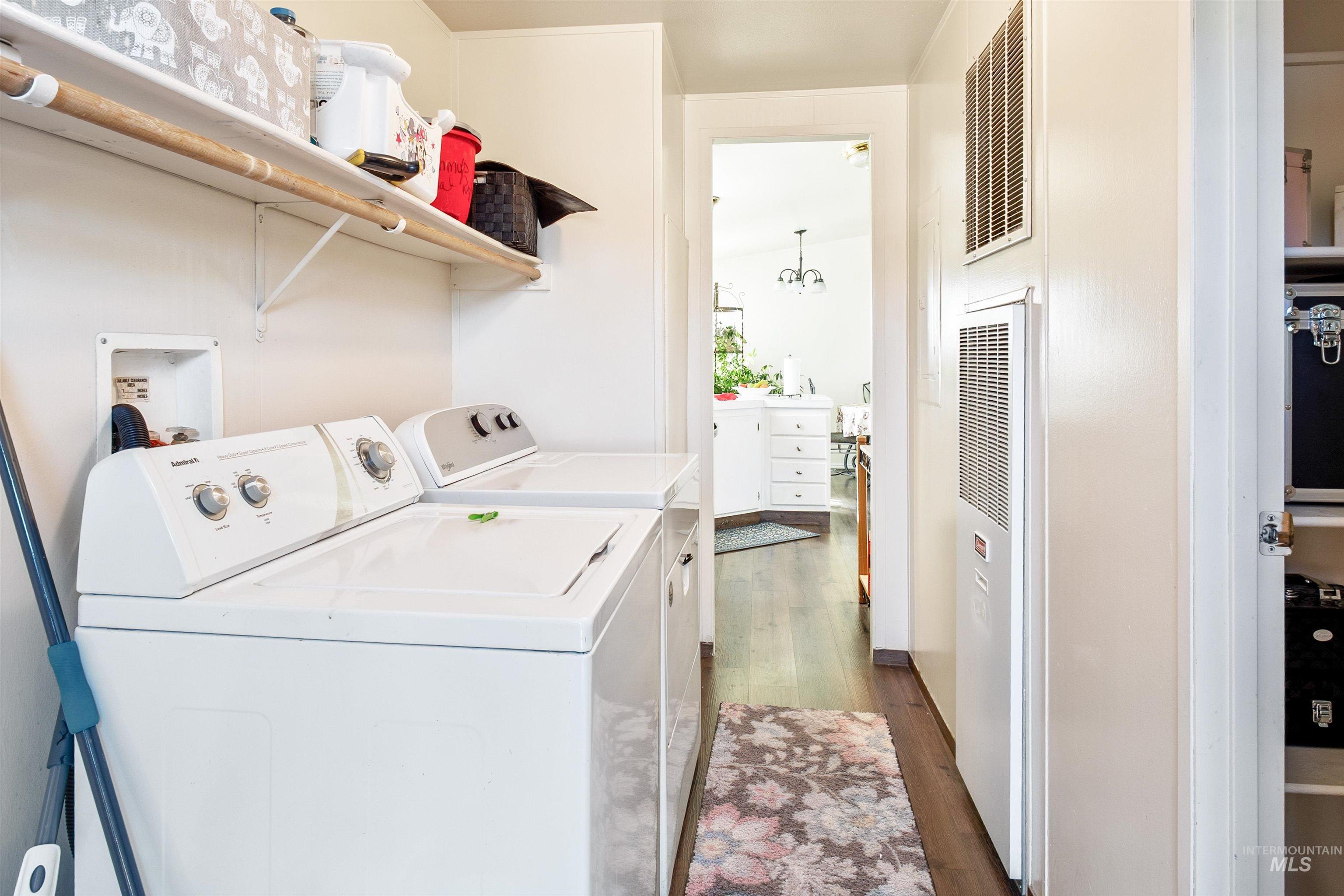 524 West Mesquite Street Boise, ID 83713 - Photo 28 of 29 Laundry room with dark wood-style floors, a heating unit, separate washer and dryer, and a chandelier