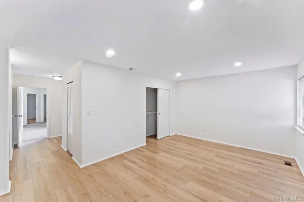 a view of hallway with wooden floor