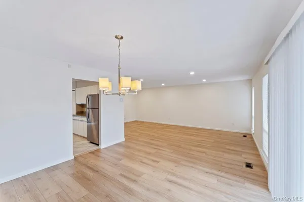 a view of a kitchen with a refrigerator and window