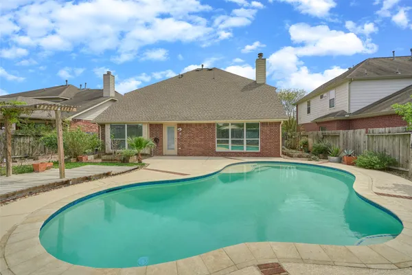 a view of a house with swimming pool and a yard