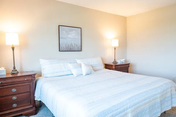 a bedroom with a bed and a night stand