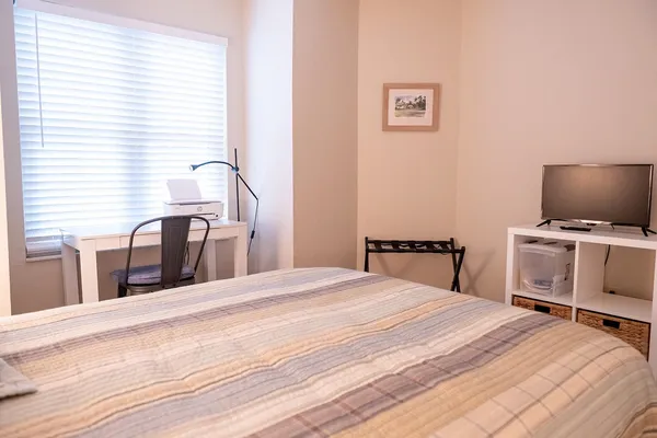 a bedroom with a bed and a window