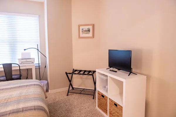 a living room with furniture and a dining table with kitchen view