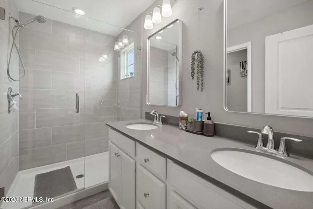 a bathroom with a granite countertop sink mirror and double