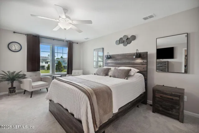 a bedroom with a large bed and a window