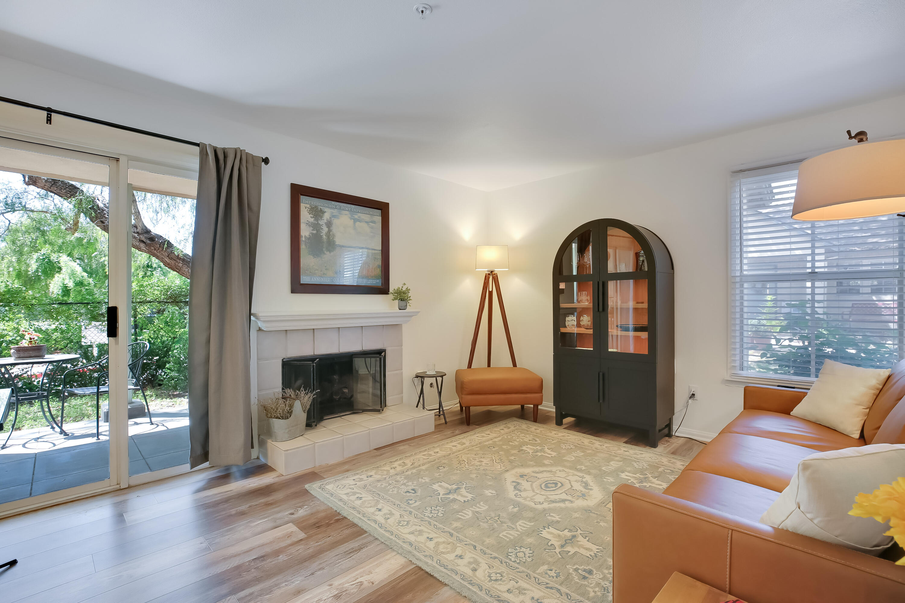 317 5th Street, Unit C Solvang, CA 93463 - Photo 1 of 24 a living room with furniture a fireplace and a floor to ceiling window