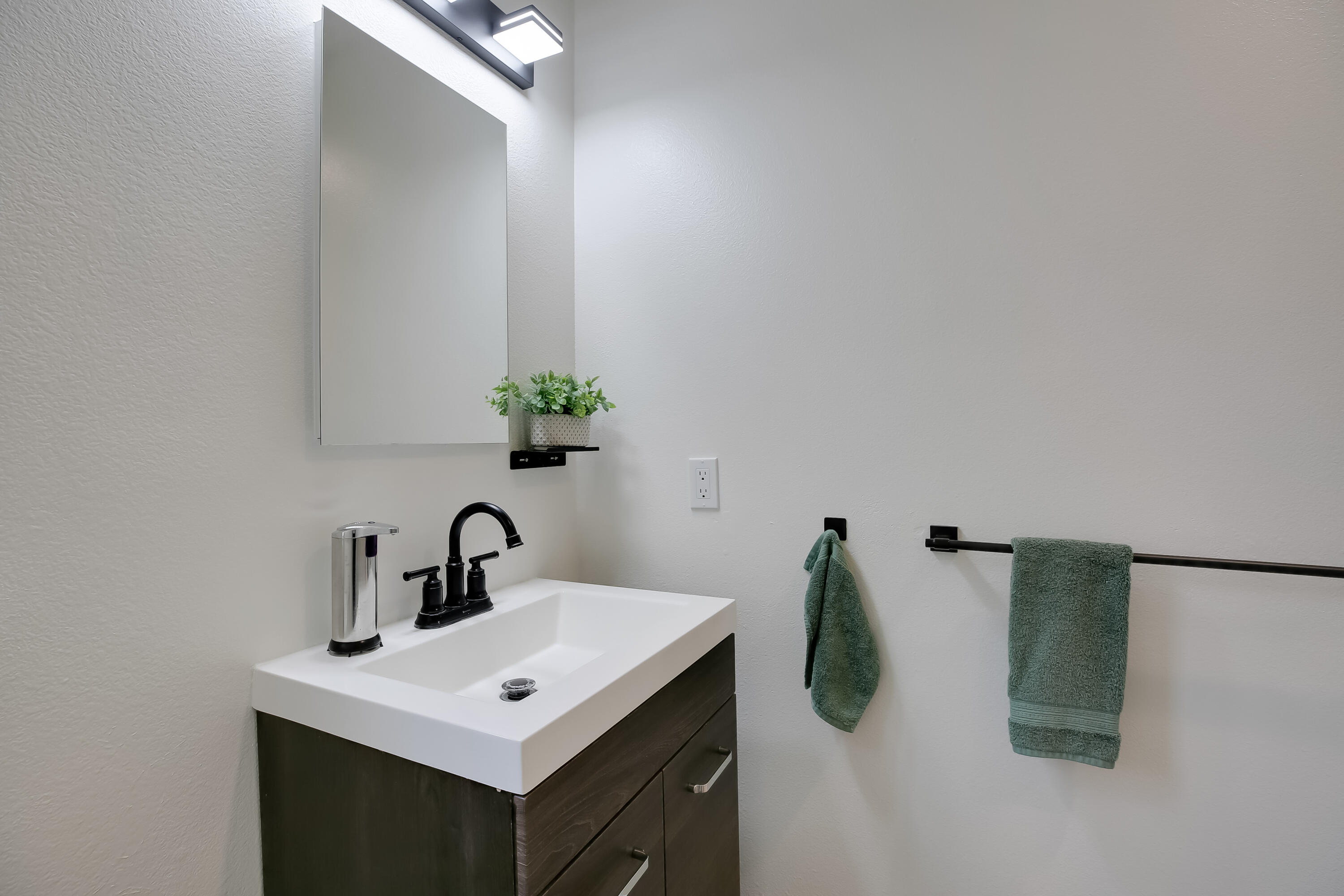 317 5th Street, Unit C Solvang, CA 93463 - Photo 17 of 24 a bathroom with a sink and mirror