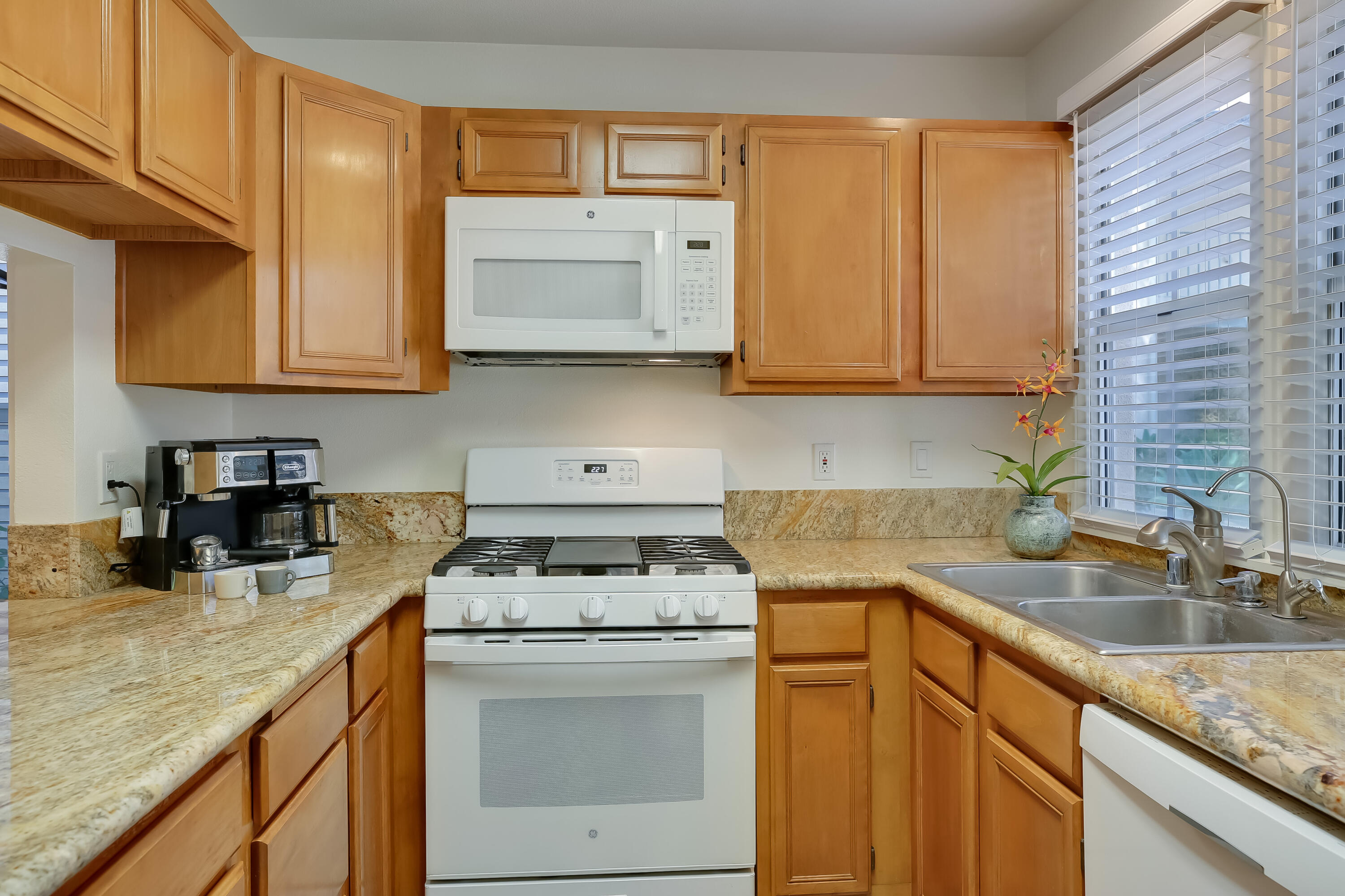 317 5th Street, Unit C Solvang, CA 93463 - Photo 7 of 24 a kitchen with a sink stove and cabinets