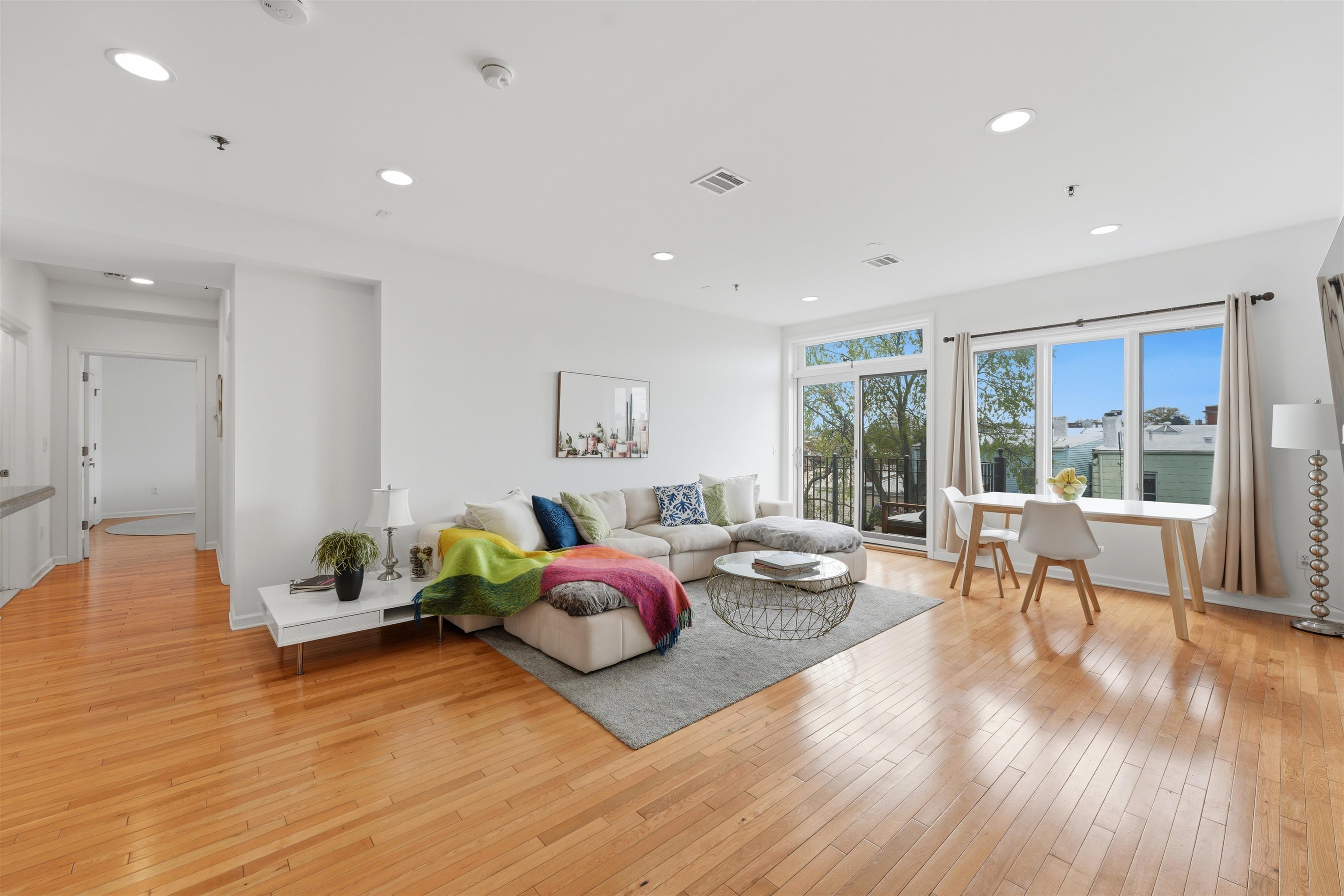 203-207 Hackensack Plank Road, Unit 5B Weehawken, NJ 07086 - Photo 1 of 25 a living room with furniture and a large window