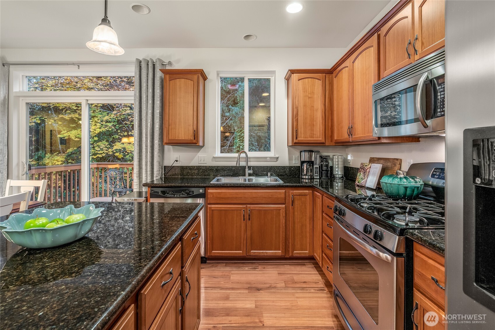 16239 2nd Place South Seattle, WA 98148 - Photo 16 of 40 a kitchen with stainless steel appliances granite countertop a stove a sink and a microwave