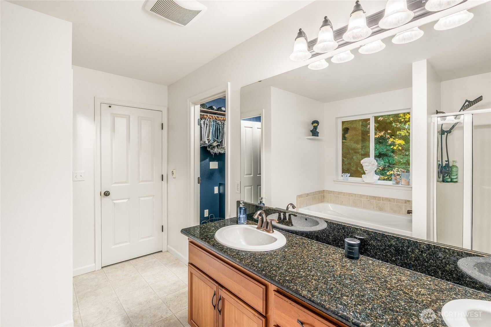 16239 2nd Place South Seattle, WA 98148 - Photo 22 of 40 a bathroom with a granite countertop sink a large mirror and a bathtub