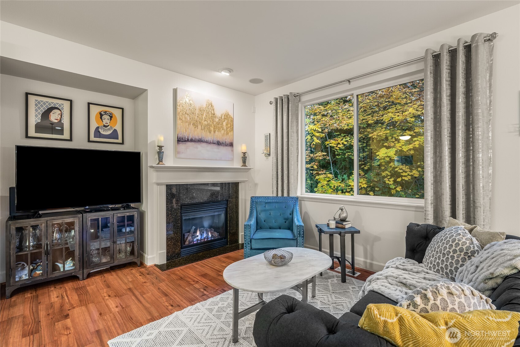 16239 2nd Place South Seattle, WA 98148 - Photo 9 of 40 a living room with furniture a flat screen tv and a fireplace
