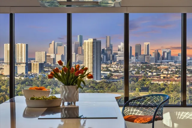 a kitchen with a large counter top stainless steel appliances and a large window